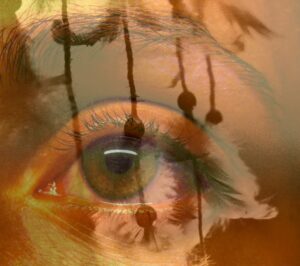 A close-up of a woman's eyeball with a transparent photo of linked ropes superimposed over it